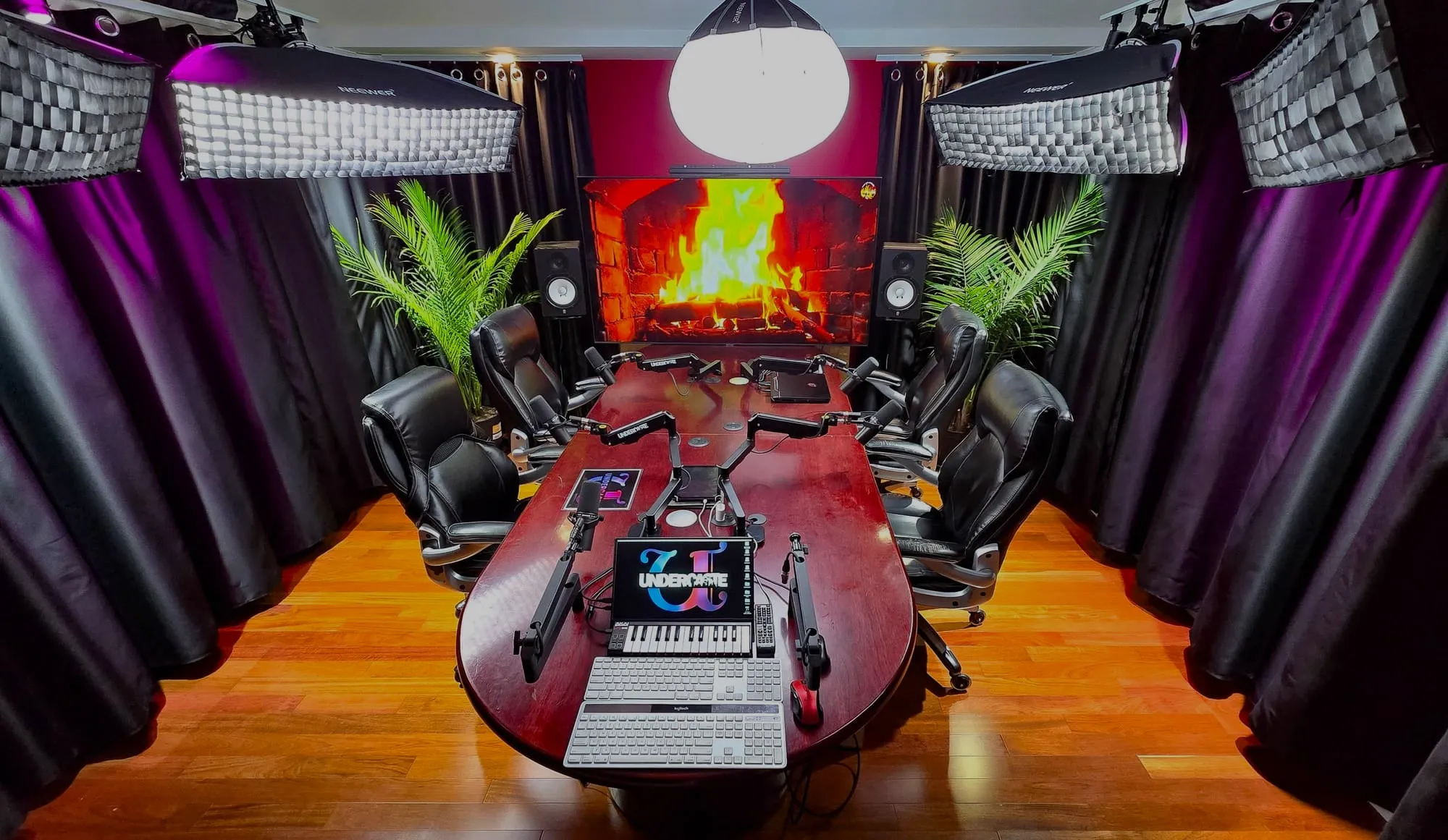 The podcast room: round table, broadcast mics, softbox lighting.