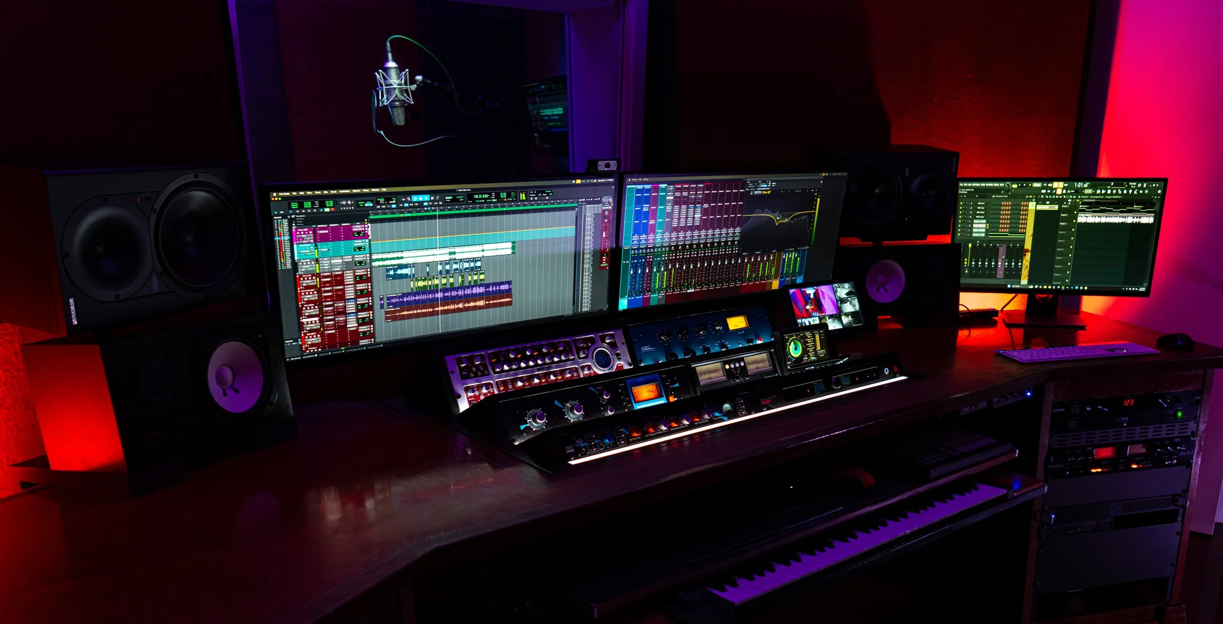Studio A mid-session: the mix on the screens, outboard lit, the mic waiting behind the glass.